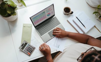 a person sitting at a table with a laptop